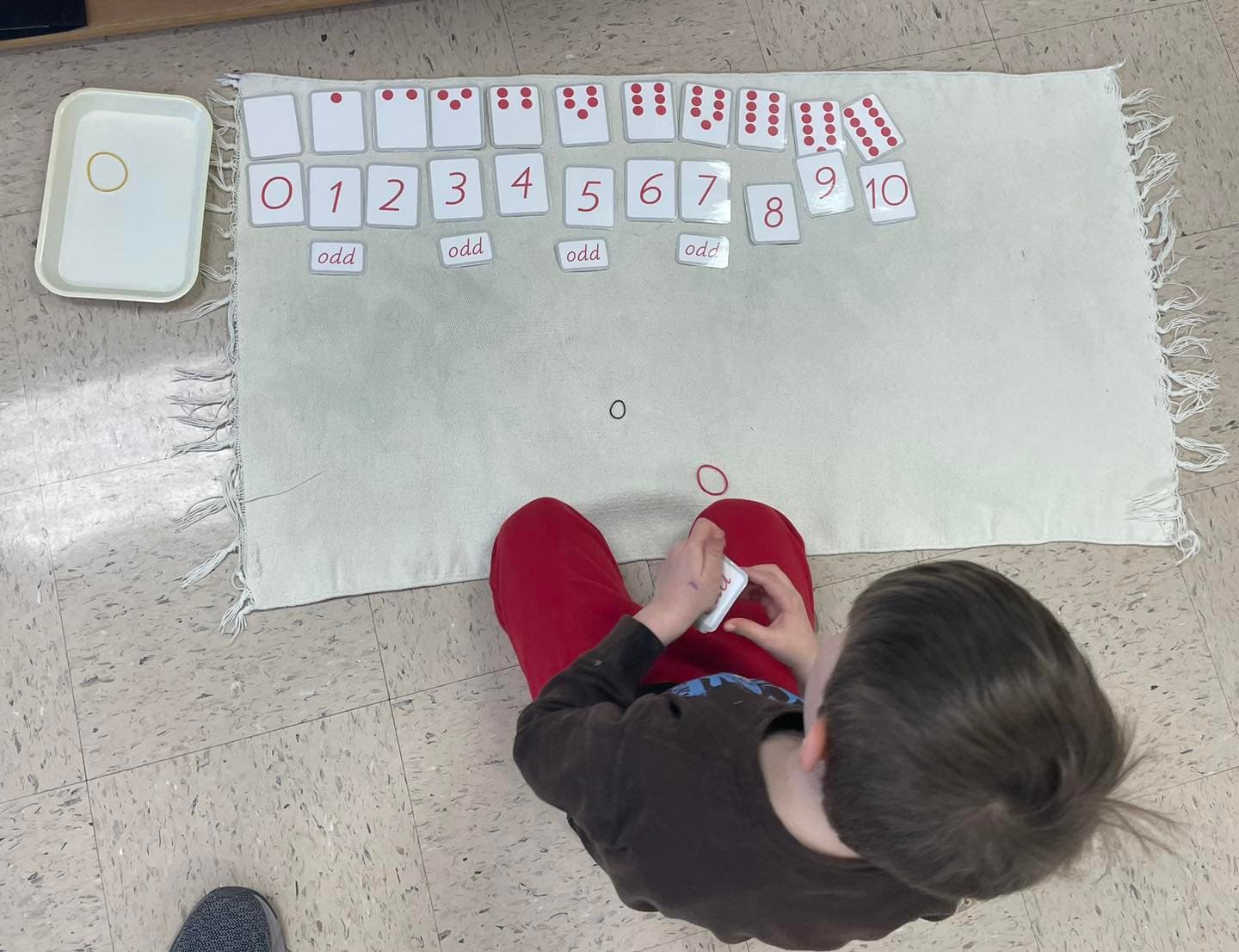 Children working with Montessori materials in a prepared classroom environment
